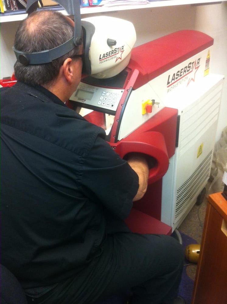 Man using a welding machine to weld jewelry 