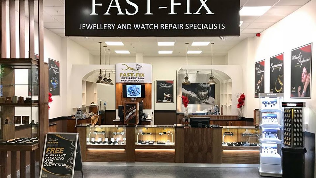 Fast-Fix Store front at Blanchardstown Centre. Shows Fast-Fix Jewelry and Watch repair specialists sign in black background and white letters. Wooden and glass sales and display stands