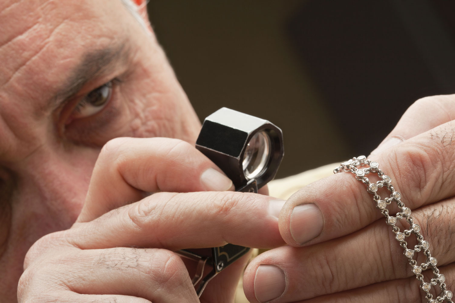 Jeweler appraising a diamond bracelet