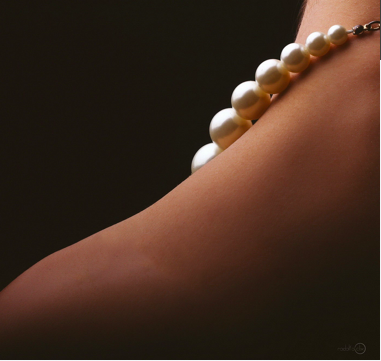 pearls necklace on a female neck showing only her left shoulder