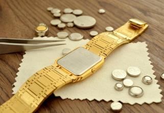 A watch next to batteries.